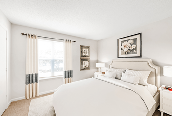 a bedroom with a large bed and a large window